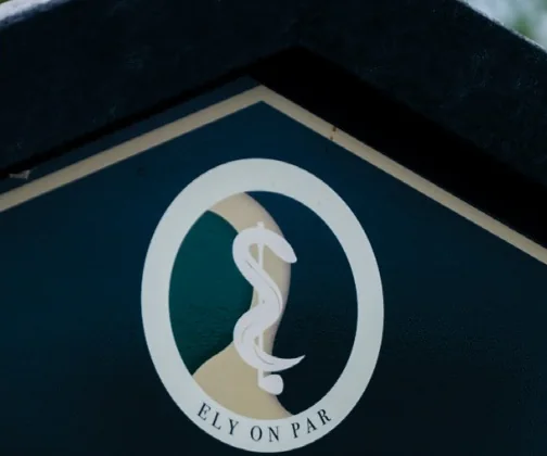 The crest of Ely on Par Golf Club on its JB Golf tee sign