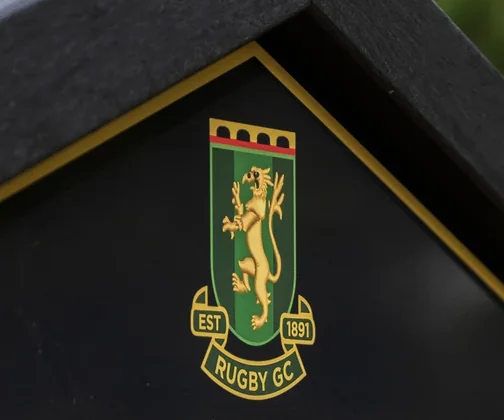The crest of Rugby Golf Club on its JB Golf tee sign
